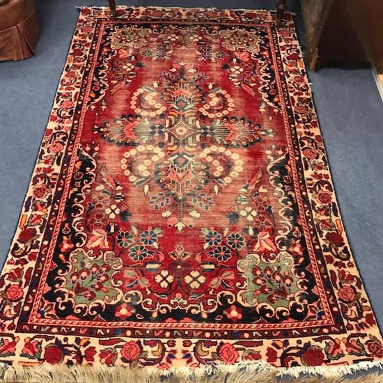 A red ground rug 218cm x135cm
